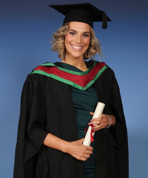 The image features a person wearing a graduation gown, The individual is celebrating their academic achievements, as indicated by the mortarboard hat and diploma.