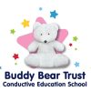 A white teddy bear sitting on a pink star surrounded by smaller colorful stars. The text "Buddy Bear Trust Conductive Education School"